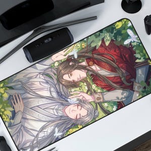 Puede incluir: Alfombrilla de ratón rectangular con una ilustración de estilo anime de dos figuras tumbadas en un campo de flores. Una figura viste de rojo y dorado, la otra de blanco. Mariposas y vegetación las rodean.