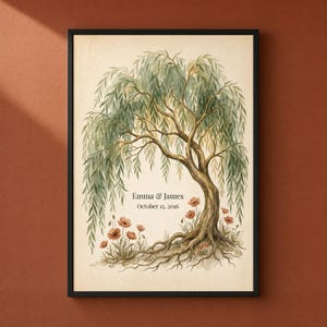 May include: A framed wall art print featuring a watercolor illustration of a large willow tree with green foliage and exposed roots. Small orange flowers grow at the base. The text "Emma & James" and "October 15, 2016" is printed in black.