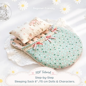 May include: A doll sleeping sack with a mint green and pink polka dot exterior, featuring three small pink ribbon bows and lace trim. It includes a matching floral print pillow and inner lining. Text reads: PDF Tutorial Step-by-Step Sleeping Sack 6" /15 cm Dolls & Characters.