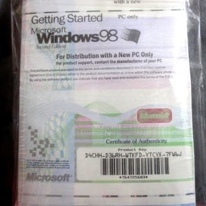 May include: Sealed Microsoft Windows 98 Second Edition software package. The packaging includes the Microsoft logo, product key, and the text "Getting Started." The package is in a clear plastic wrap.