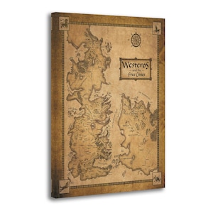May include: A canvas print of a detailed map of Westeros and the Free Cities, in shades of brown and tan. The map includes geographical features, place names, and a compass rose. The title "Westeros and the Free Cities" is displayed in a rectangular frame.