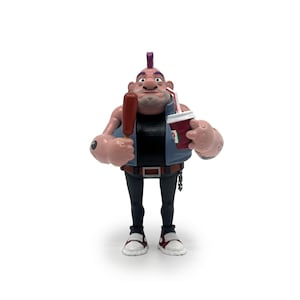 May include: A figurine of a muscular character with a purple mohawk, wearing a black shirt, blue vest, and black pants. The figure holds a red popsicle and a drink with a straw. The figure is wearing a watch and has tattoos.