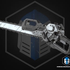 May include: A gray and silver chainsaw with a blade featuring the text "GALACTIC ARMORY". The chainsaw has a futuristic design with a handle and a trigger. The image also includes a logo and a website address.