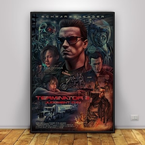 May include: A framed movie poster for "Terminator 2: Judgment Day" featuring Arnold Schwarzenegger. The poster has a dark color scheme with images of characters, a truck, and the film's title in red. The poster is in a black frame.