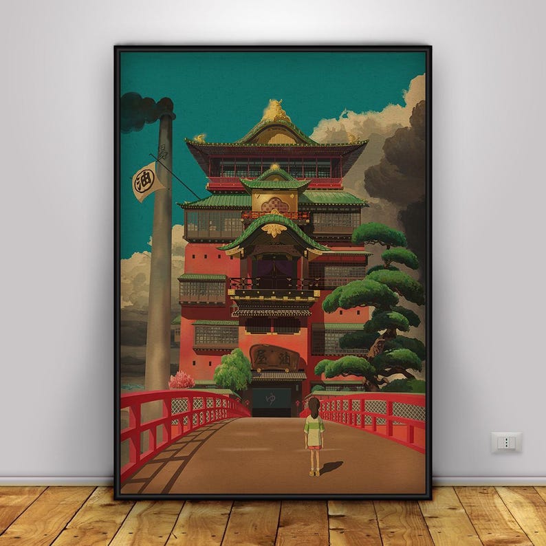 May include: A framed art print featuring a vibrant illustration of a Japanese bathhouse. The artwork showcases a red bridge, a detailed building with green roofs, and a young girl. The sky is a mix of blue and clouds, with a smokestack in the background.