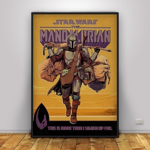 May include: Framed poster with a Star Wars The Mandalorian illustration. The artwork shows the Mandalorian walking across a desert, carrying equipment and a small creature. Text includes "STAR WARS THE MANDALORIAN" and "THIS IS MORE THAN I SIGNED UP FOR."
