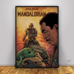 May include: Framed poster featuring characters from "Star Wars: The Mandalorian." The artwork includes the Mandalorian, Grogu, and other characters. The poster has a warm colour palette with a black frame.
