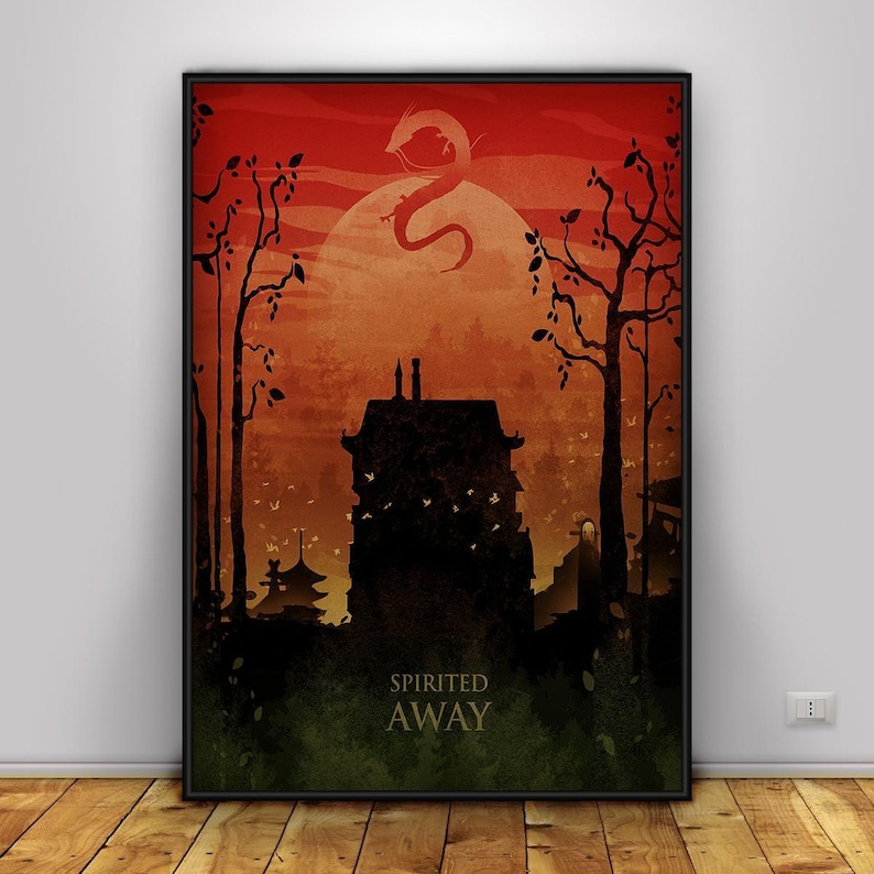 May include: A framed art print featuring a silhouette of a building and trees against a sunset-colored sky. A white dragon is above the building. The words "SPIRITED AWAY" are at the bottom of the print.