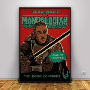 May include: A framed poster for Star Wars: The Mandalorian. The image shows a man with a moustache, holding a lightsaber. Text includes "STAR WARS THE MANDALORIAN" and "LONG LIVE THE EMPIRE!" in a retro style.