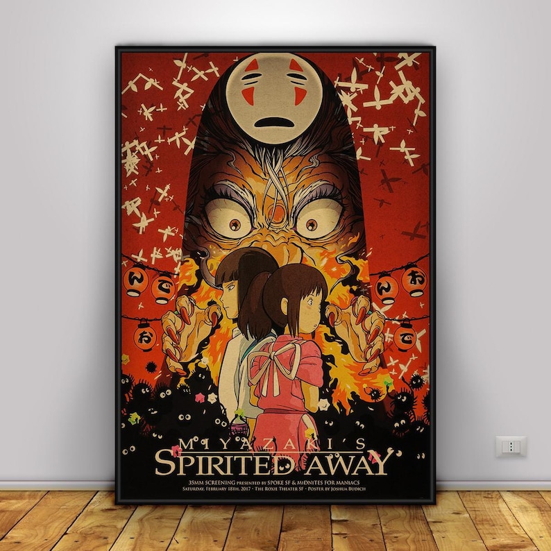 Op de afbeelding: Een ingelijste poster van de animatiefilm "Spirited Away." De afbeelding toont personages en beelden uit de film, met een rood en oranje kleurenschema. De poster bevat Japanse tekst en de titel van de film.