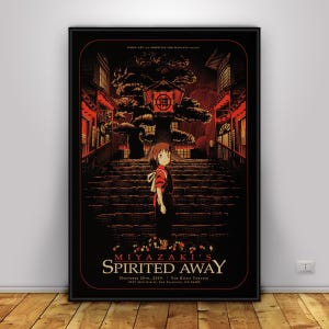Op de afbeelding: Een ingelijste poster met een sc&egrave;ne uit Miyazaki's Spirited Away. Het kunstwerk toont een jong meisje op een trap, met een gebouw in Japanse stijl op de achtergrond. Het kleurenpalet is voornamelijk rood en zwart, met de titeltekst onderaan.