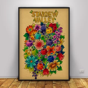 May include: A framed poster featuring the words "Stardew Valley" above a colorful illustration. The artwork showcases a vibrant bouquet of flowers and anthropomorphic fruit characters in various colors, set against a tan background.