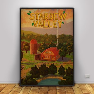 May include: A framed poster featuring a rural landscape with a red-roofed house, silo, and pond. The words "Stardew Valley" are at the top in a wooden-style font. The artwork has a warm, inviting color palette.
