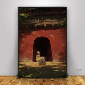 May include: A framed art print depicting a young person in a white dress standing before a large, red arched doorway. The artwork has a fantasy theme, with a stone and foliage in the foreground.