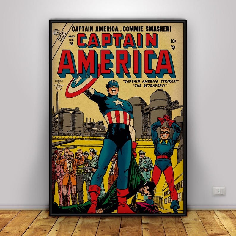 May include: A framed vintage comic book cover featuring Captain America. The cover has a yellow background with the title "CAPTAIN AMERICA" in large red letters. Captain America is in a blue and red costume, holding his shield. The text reads "CAPTAIN AMERICA STRIKES!" and "THE BETRAYERS!"