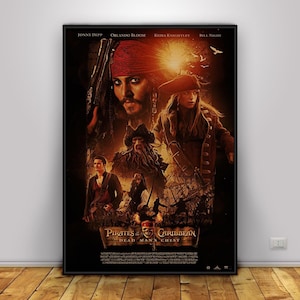 May include: Framed movie poster for "Pirates of the Caribbean: Dead Man's Chest" featuring Johnny Depp, Orlando Bloom, Keira Knightley, and Bill Nighy. The poster has a dark, dramatic design with pirate-themed imagery and text.