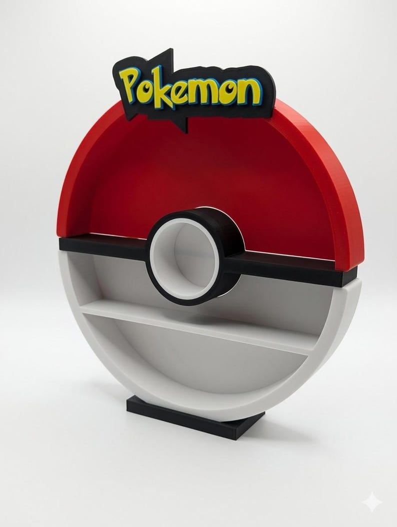 May include: A red, black, and white Pokemon-themed shelf shaped like a Poke Ball. The top features the word "Pokemon" in yellow and blue lettering. The shelf has two levels and a circular design, perfect for displaying collectibles.