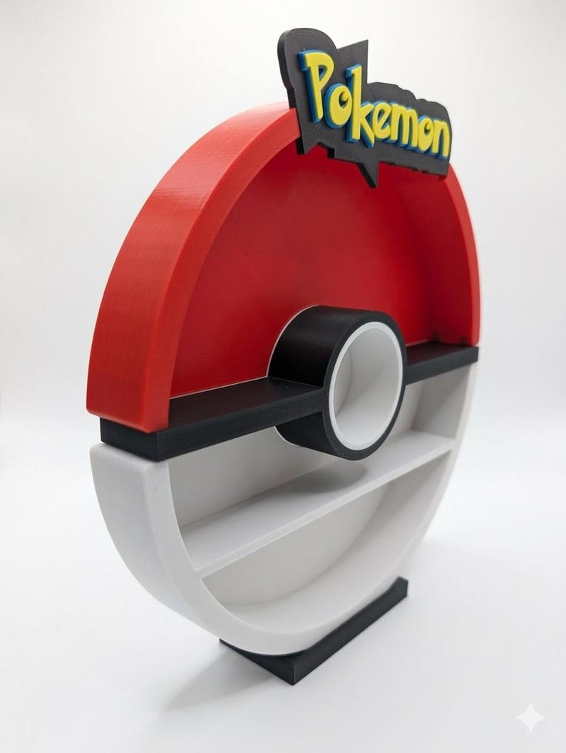 May include: A red, black, and white shelf unit shaped like a Pok&eacute; Ball. The top features the word "Pokemon" in yellow and blue. The shelf has two interior shelves and a black base.