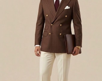 May include: A brown pinstripe double-breasted suit with cream trousers and brown leather loafers. The suit has gold buttons and a white pocket square. A brown leather portfolio is held. The suit is a classic formal style.