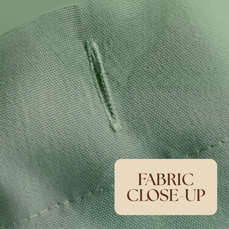 May include: A sage green fabric with a visible woven texture and a single vertical buttonhole. The material features a consistent weave pattern and a clean, finished edge. A rectangular label with the text FABRIC CLOSE-UP is visible.