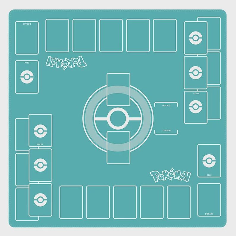 May include: A teal playmat for a card game, featuring a layout with designated areas for cards and game elements. White outlines define card zones, a central game area, and the word "Pok&eacute;mon" in white. The mat is designed for organized gameplay.