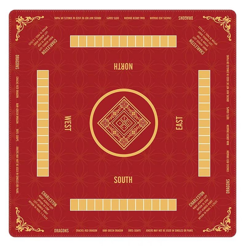 May include: A square red Mahjong mat featuring a central gold diamond emblem, four player positions labeled North, South, East, and West, and printed instructions for Charleston and Dragon rules in gold text along the edges and corners.