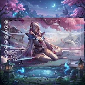 May include: A playmat featuring a serene anime-style illustration. A woman in a white and blue outfit is petting a white creature. The background shows a Japanese garden with cherry blossoms, a pond, and a pagoda. The words "LEAGUE OF LEGENDS" are visible.