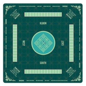 May include: A square dark green Mahjong mat featuring a central light green circle with a diamond pattern. The mat includes four rectangular tile racks, directional labels for North, South, East, and West, and printed text detailing Charleston rules.
