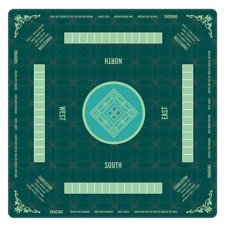 May include: A square dark green Mahjong mat featuring a central light green circle with a diamond pattern. The mat includes four rectangular tile racks, directional labels for North, South, East, and West, and printed text detailing Charleston rules.
