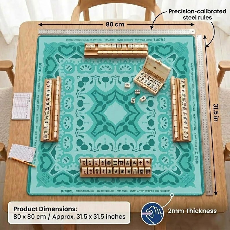 May include: A square Mahjong game set with a teal patterned playing surface, wooden tiles, and accessories. The table measures 31.5 x 31.5 inches and has precision-calibrated steel rules. The set includes wooden tile racks and a wooden box.