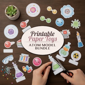 May include: A collection of science-themed paper cutouts including atom models, laboratory glassware, and chemical symbols. A central oval label reads Printable Paper Toys ATOM MODEL BUNDLE. Scissors are shown cutting a paper flask cutout.