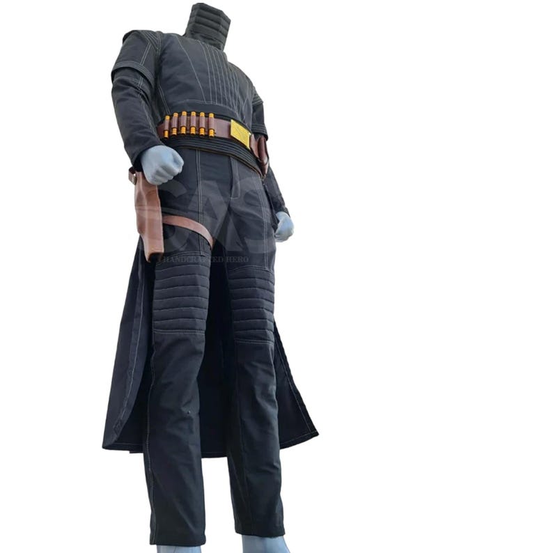 May include: A black long-sleeved jacket and matching trousers set featuring quilted knee and shoulder panels, white contrast stitching, and a brown utility belt with gold-toned cylindrical accents and a holster attached to the right hip.