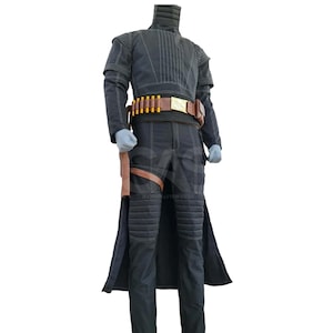May include: A black long-sleeved jacket and matching trousers set featuring quilted padding on the shoulders, neck, and knees. A brown leather utility belt with yellow cylindrical accents and a holster is worn around the waist over the dark outfit.