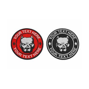 May include: Two circular embroidered patches featuring a dog's head. One is red with a black and white dog head and the text "YOUR TEXT HERE". The other is black with a white dog head and the same text.