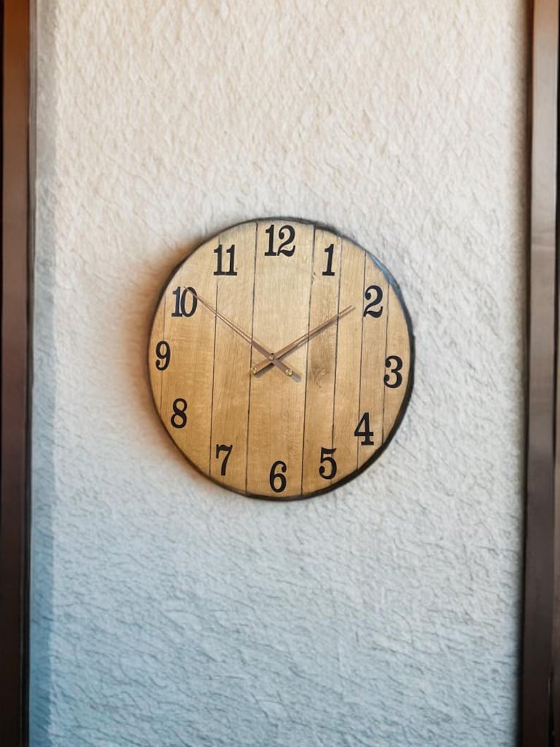 Whisky barrel-lid charity clock mounted on a wall