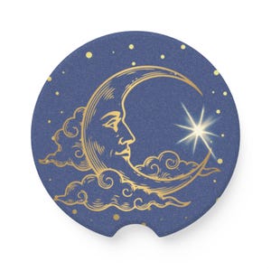 May include: A navy blue car coaster featuring a gold crescent moon with a face, surrounded by clouds and a star. The design includes small gold stars scattered across the background.