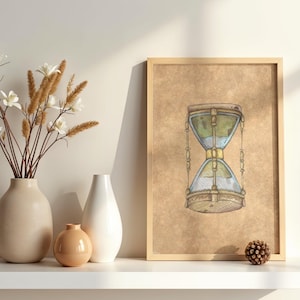 May include: A framed print of an hourglass illustration in shades of green, blue, and gold. The artwork is displayed on a shelf with neutral-toned vases and decorative flowers. A pinecone adds a natural element.