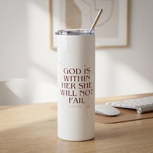 May include: A white ceramic mug with a black handle and the text "But First, Coffee" in a handwritten style. The mug is on a white surface. The mug is approximately 10 cm tall.