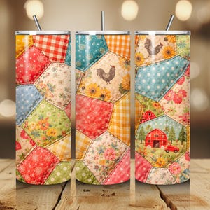 May include: A cylindrical tumbler with a straw featuring a colorful patchwork quilt pattern. The design includes hexagonal segments with floral prints, red and yellow gingham, polka dots, sunflowers, a rooster, and a red barn with a red truck.