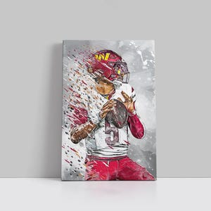 May include: Canvas print of a football player in a red and white uniform, holding a football. The player wears a red helmet with a gold logo. The artwork has a watercolour effect with splashes of red, white, and grey.