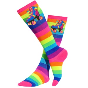 May include: A pair of knee-high socks with a rainbow stripe pattern and a roller skate graphic. The roller skate is pink, blue, and yellow with rainbow wings.