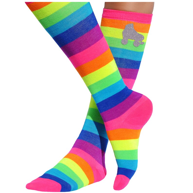 May include: Rainbow striped knee-high socks with a silver glitter roller skate design on one sock.