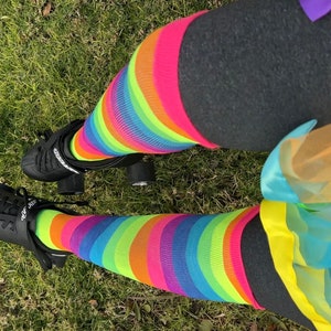 a person wearing colorful socks and black shoes