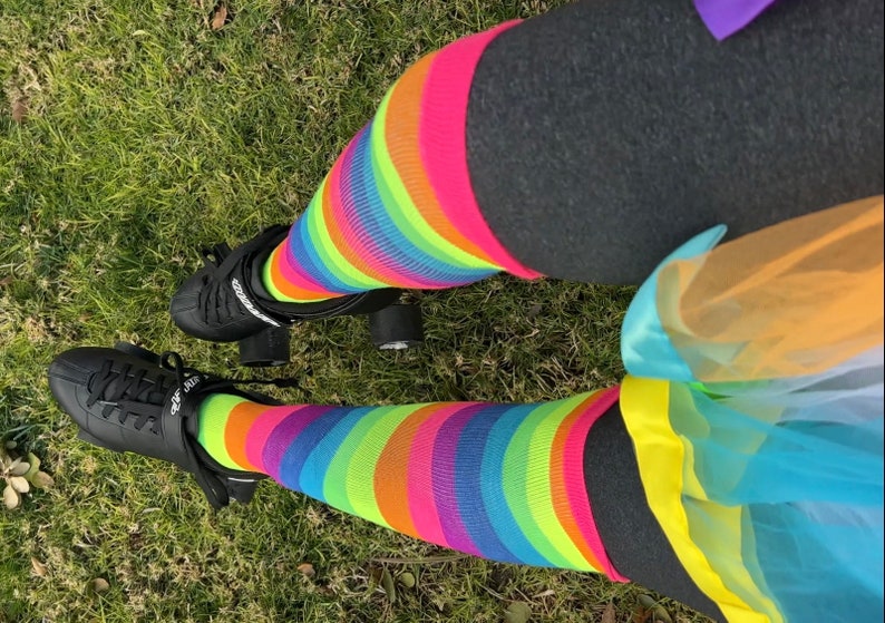 a person wearing colorful socks and black shoes