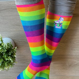 a person standing on a wooden floor wearing colorful socks