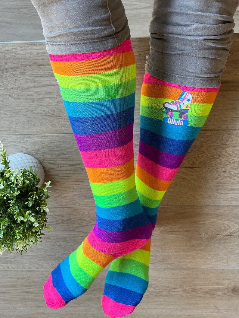 a person standing on a wooden floor wearing colorful socks