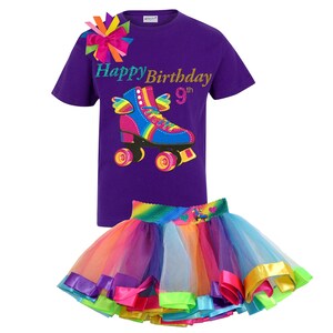 May include: Purple t-shirt with a rainbow roller skate graphic and the text "Happy Birthday 9th". A rainbow tulle skirt with colourful satin ribbon trim.