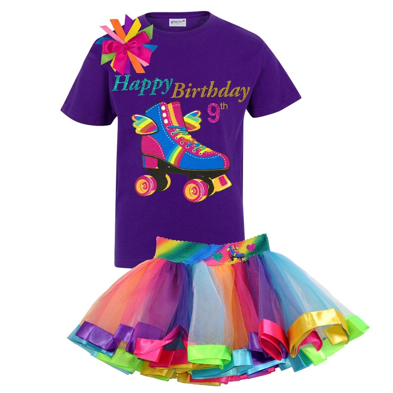 May include: Purple t-shirt with a rainbow roller skate graphic and the text "Happy Birthday 9th". A rainbow tulle skirt with colourful satin ribbon trim.