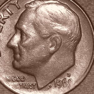 May include: A silver-coloured United States ten-cent coin featuring the profile of Franklin D. Roosevelt facing left. The word LIBERTY is embossed along the left edge, with IN GOD WE TRUST and the year 1969 printed at the bottom of the coin face.