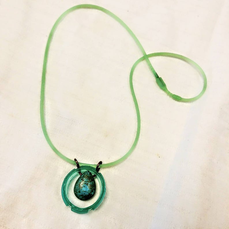 Seaside necklace simply elegant every day upcycled water bottle holding a dyed magnasite tear drop shaped stone turquoise color.